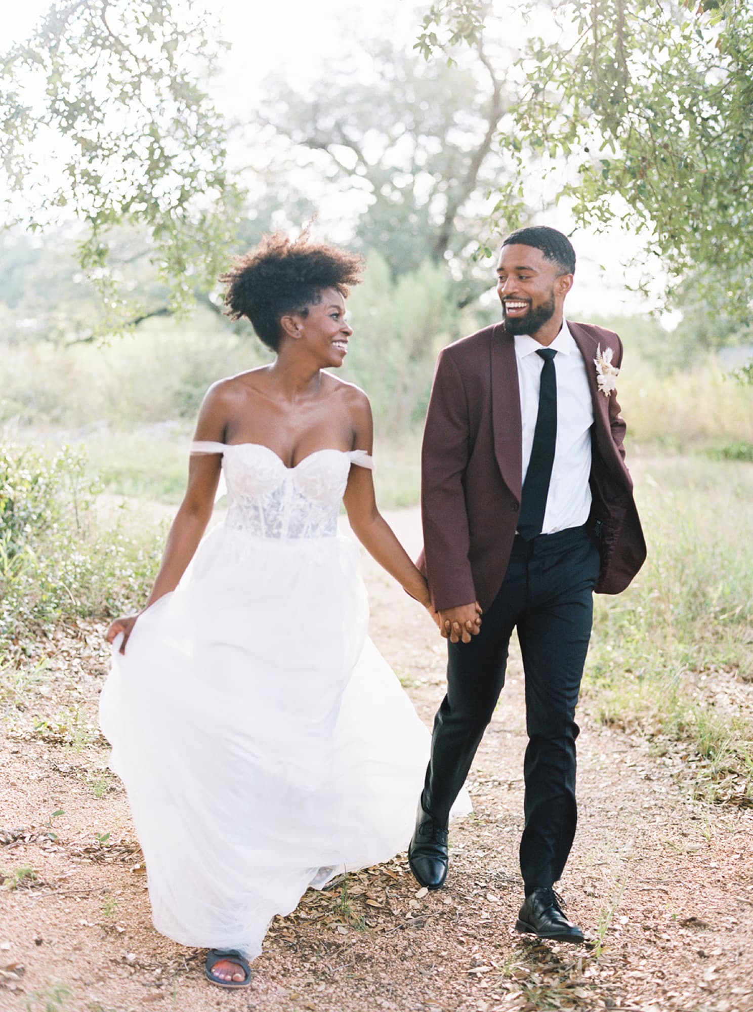 Abyon Ausar walking with a bride in an open field