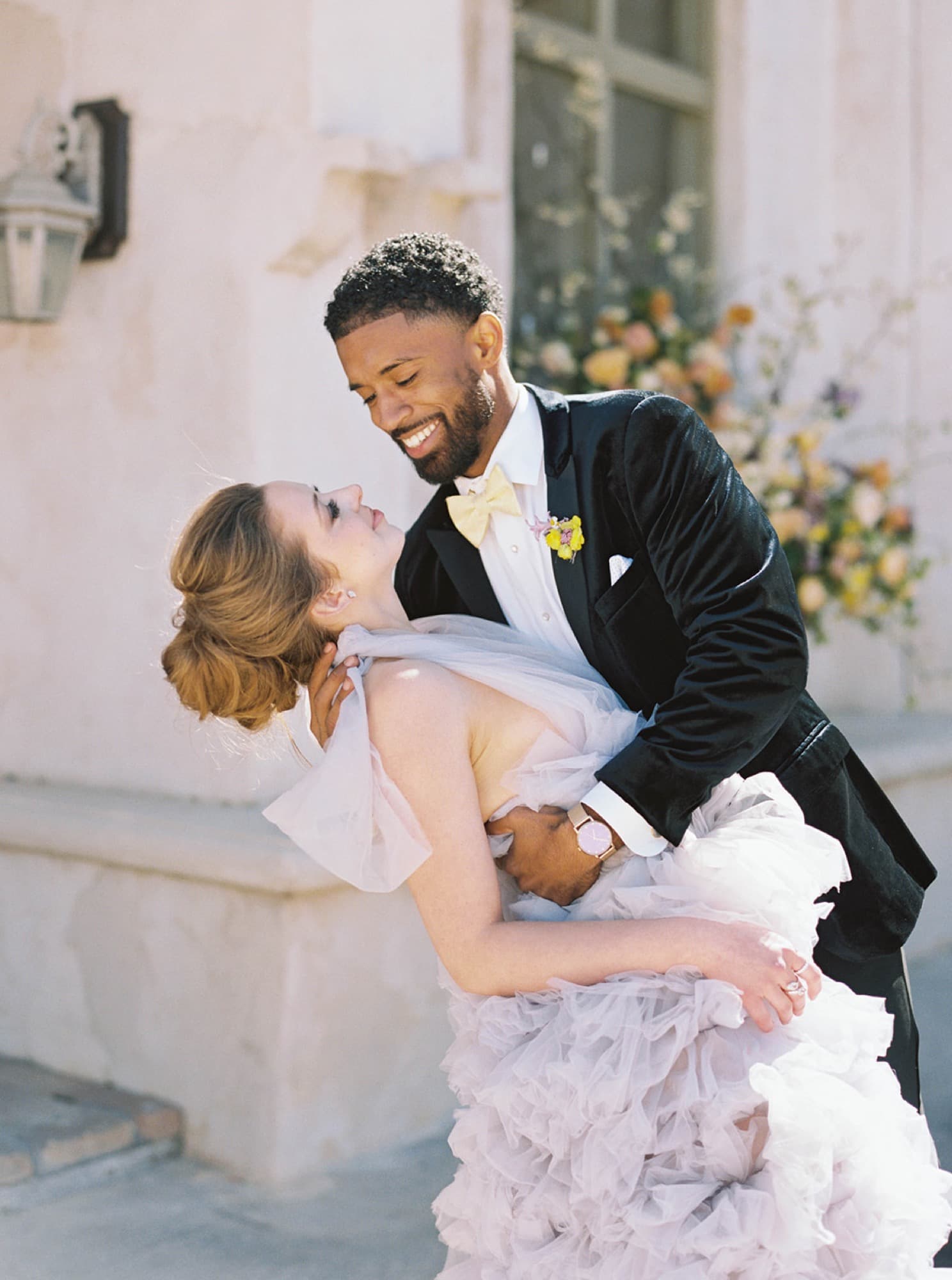 Abyon Ausar dipping a bride in a lilac gown