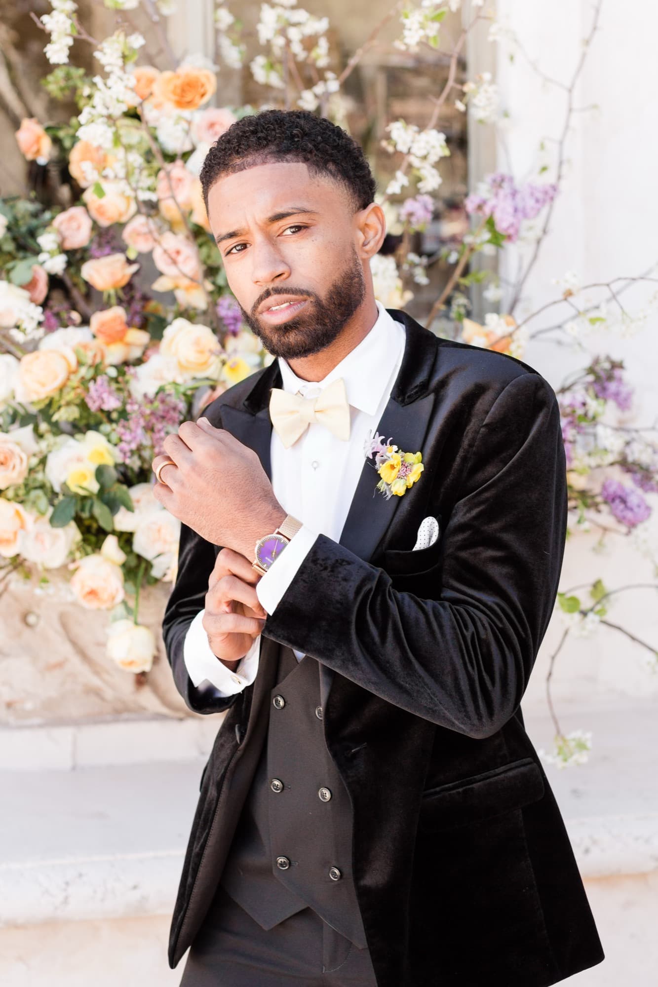 Abyon Ausar in a black velvet tuxedo with a boutonniere