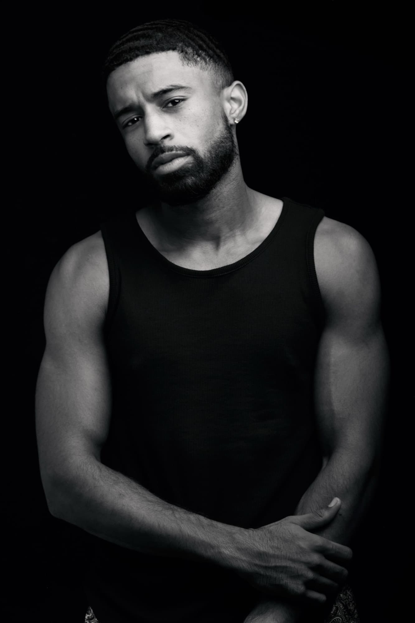 Low key studio shot of Abyon Ausar in a black tank top