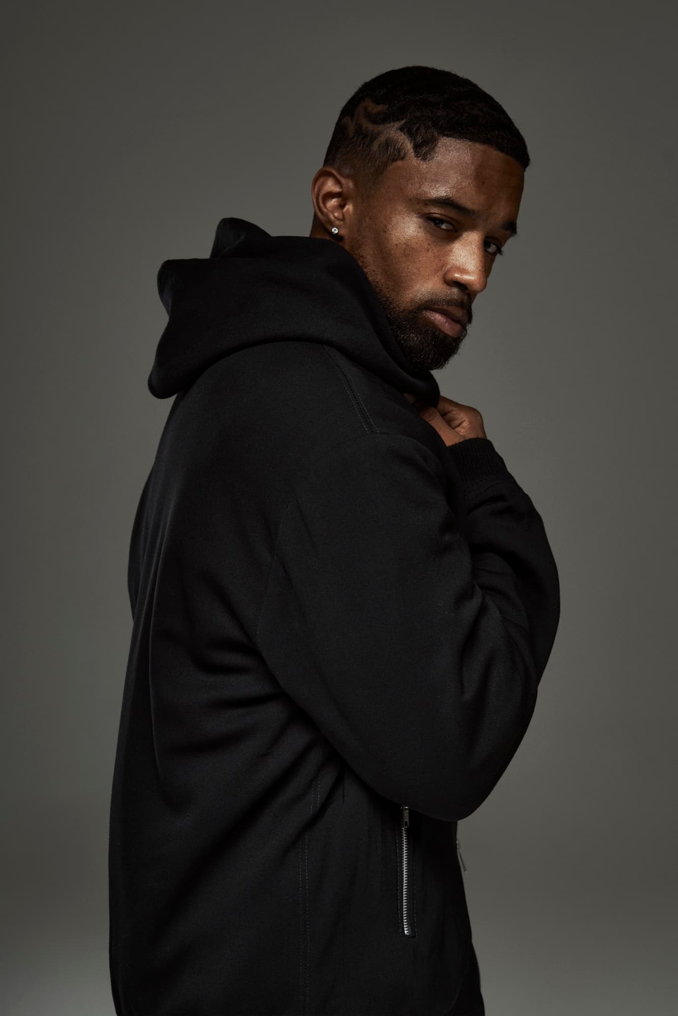 Abyon Ausar in a black hooded jacket