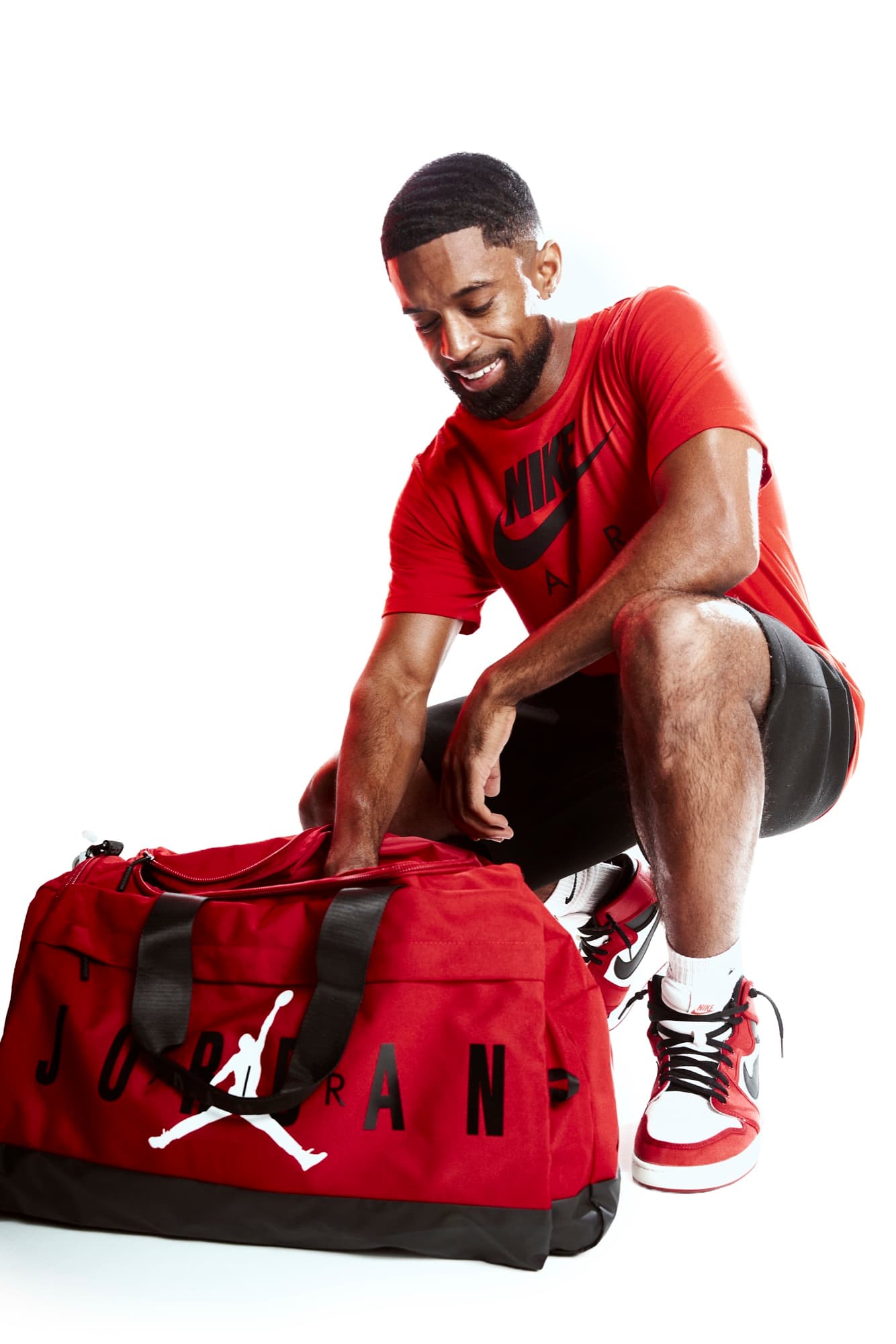 Abyon Ausar in sportswear with a kit bag