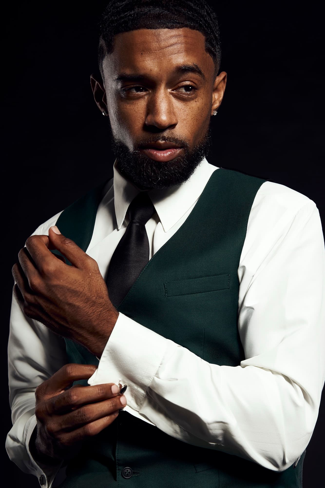 Abyon Ausar in a green waistcoat and tie